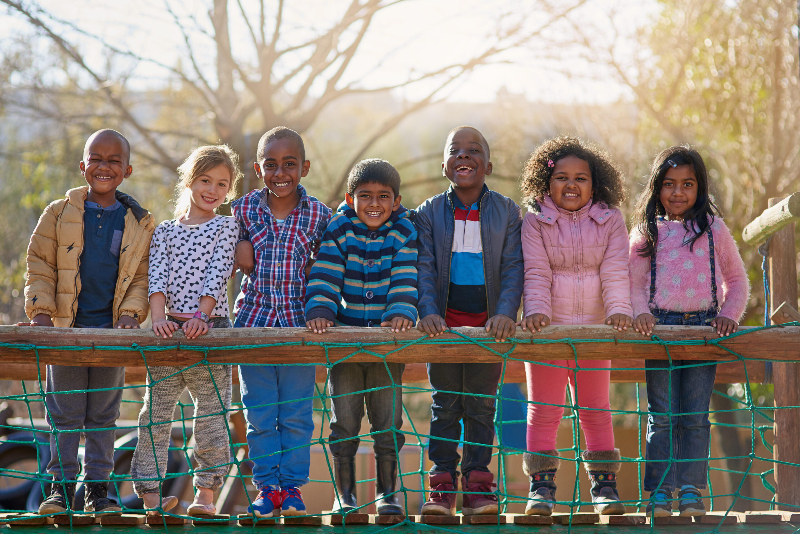 The park is our happy place. Portrait of a group of little children standing together outside