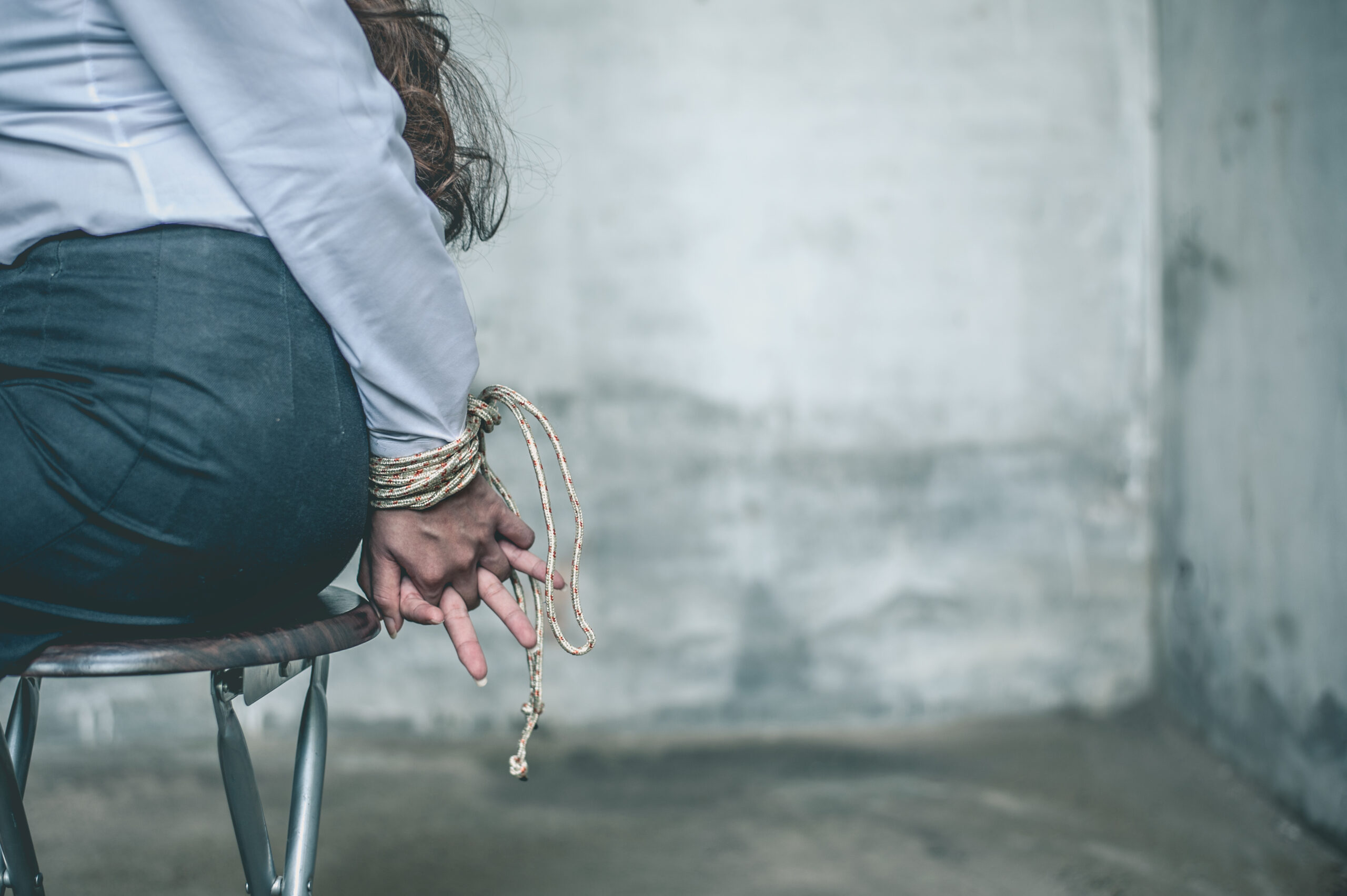 woman hands bound. Women were handcuffed and Sitting on a chair.woman tied hand to a chair.Crime Concept.Criminality Concept.
Bonded business.